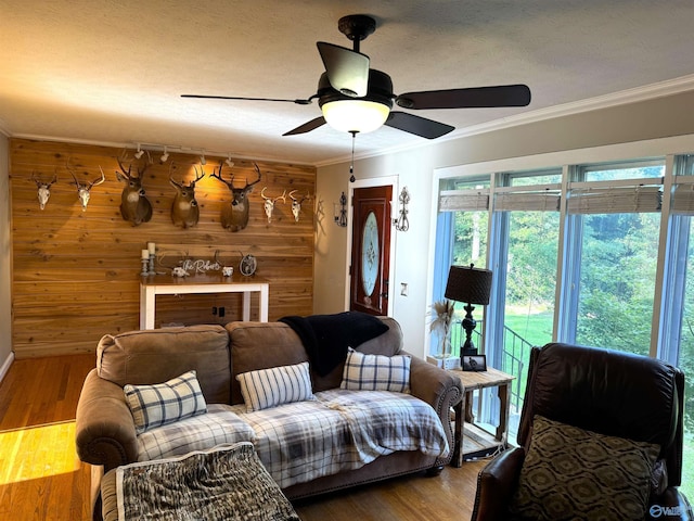 205 Pine Rd, Gadsden, AL 35901 - living area featuring wooden walls, crown molding, ceiling fan, wood finished floors, and baseboards