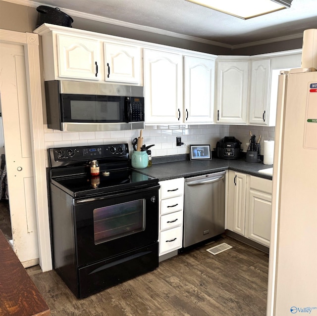 205 Pine Rd, Gadsden, AL 35901 - kitchen featuring stainless steel appliances, dark countertops, dark wood-type flooring, white cabinets, and decorative backsplash