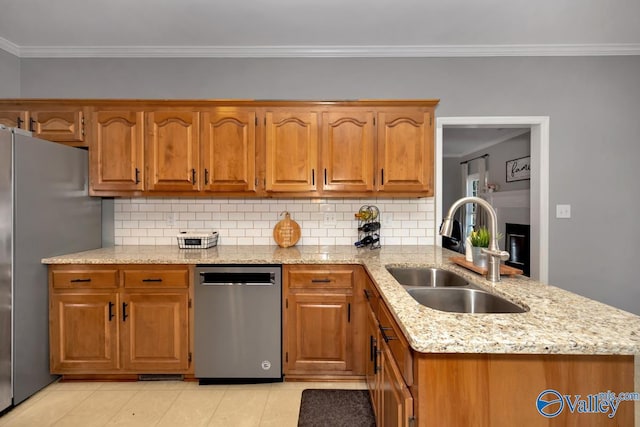 kitchen with crown molding, sink, decorative backsplash, and appliances with stainless steel finishes