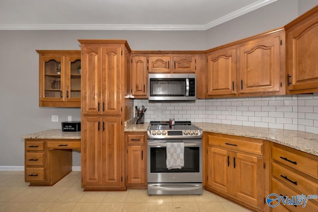 kitchen featuring crown molding, appliances with stainless steel finishes, backsplash, and light stone counters