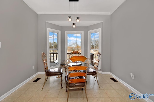 dining room with light tile patterned floors and crown molding