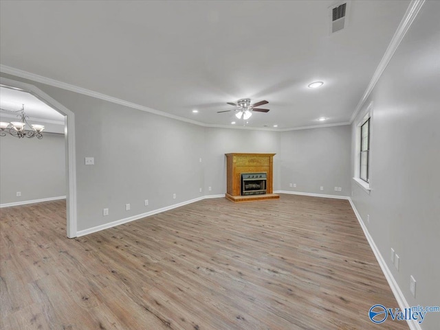 unfurnished living room with visible vents, ornamental molding, ceiling fan with notable chandelier, and recessed lighting