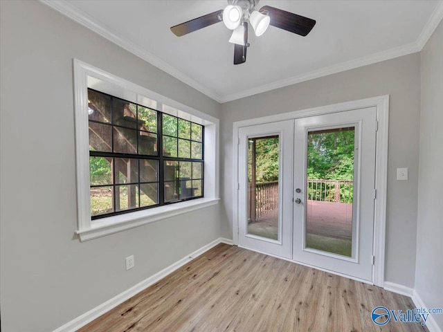 interior space featuring french doors, baseboards, plenty of natural light, and wood finished floors
