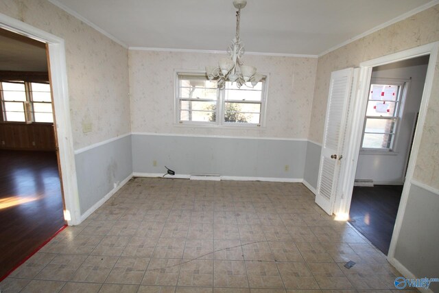 unfurnished dining area with crown molding, a chandelier, and baseboard heating
