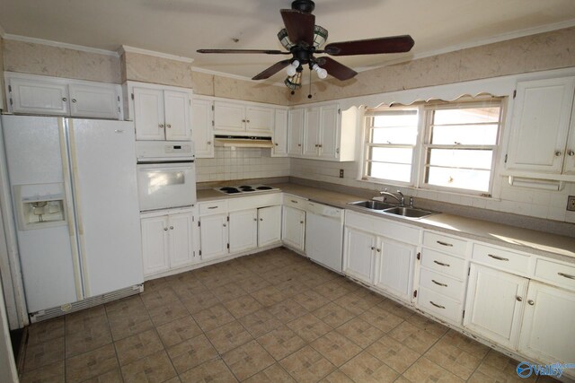 kitchen with sink, white appliances, ornamental molding, and white cabinets