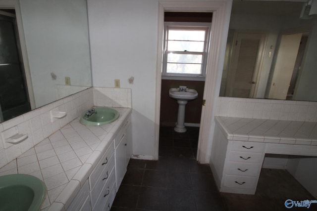 bathroom featuring tasteful backsplash, tile patterned floors, and sink