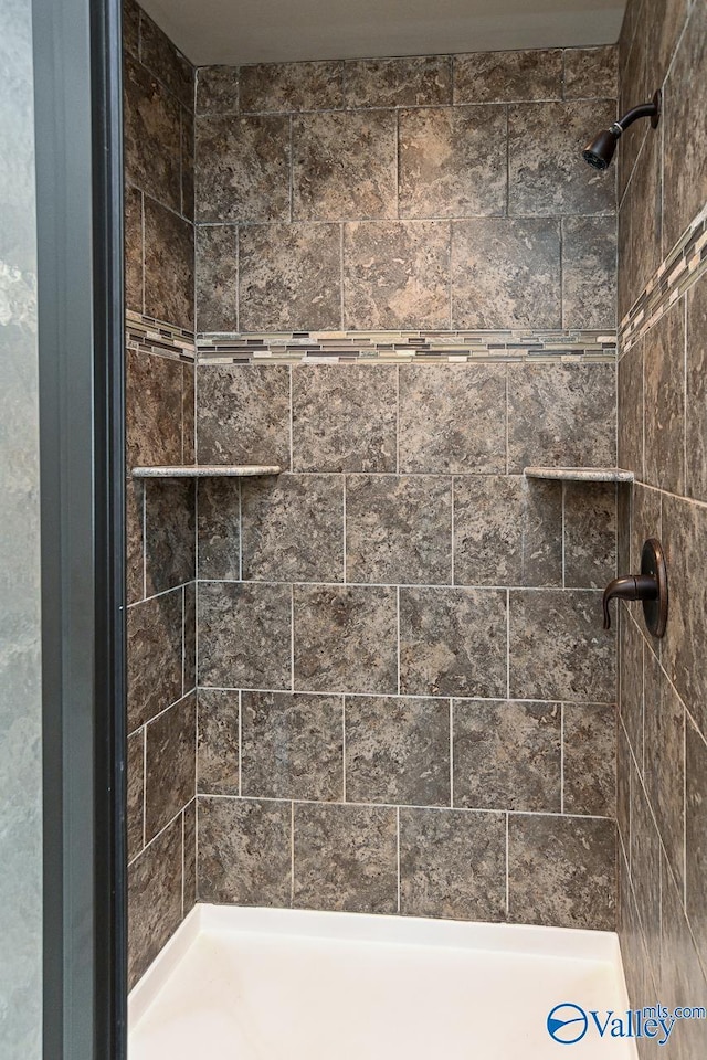 bathroom with tiled shower