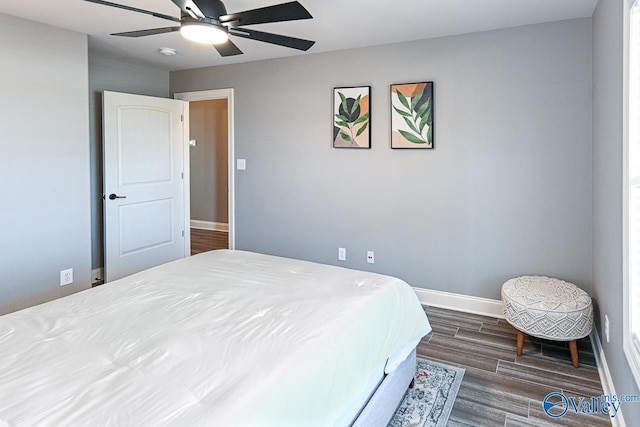 bedroom with ceiling fan and dark hardwood / wood-style flooring