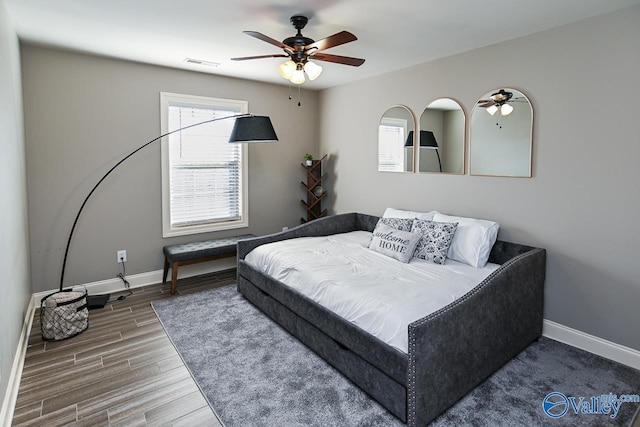 bedroom featuring hardwood / wood-style floors and ceiling fan