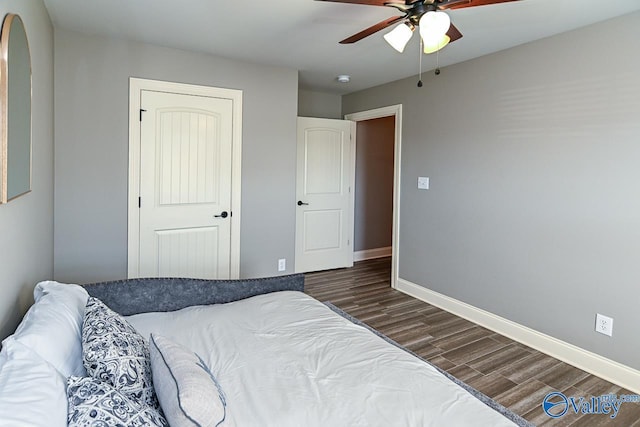 bedroom featuring ceiling fan, a closet, and dark hardwood / wood-style floors