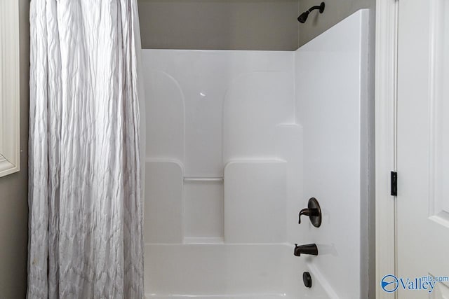 bathroom with shower / bath combo with shower curtain