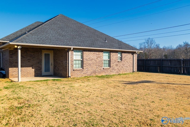 rear view of house with a lawn and a patio area