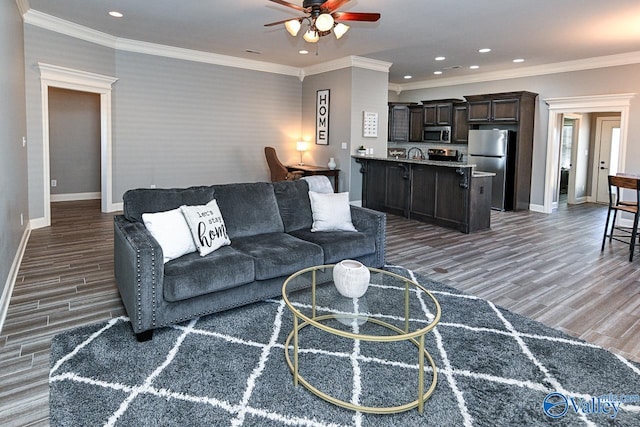 living room with ornamental molding and dark wood-type flooring