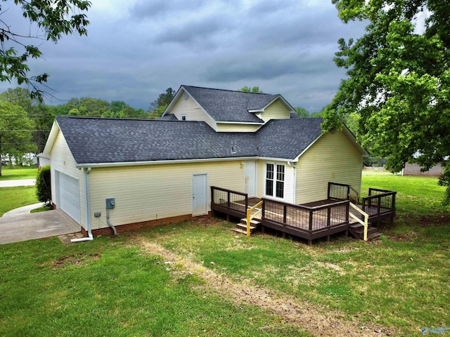 back of house with a shingled roof, a yard, driveway, and a deck