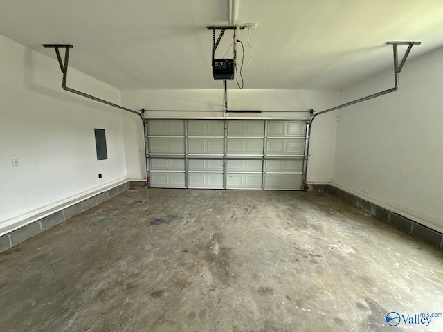 garage with a garage door opener and electric panel