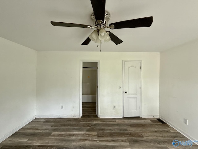 unfurnished bedroom featuring dark wood-style floors, baseboards, and ceiling fan