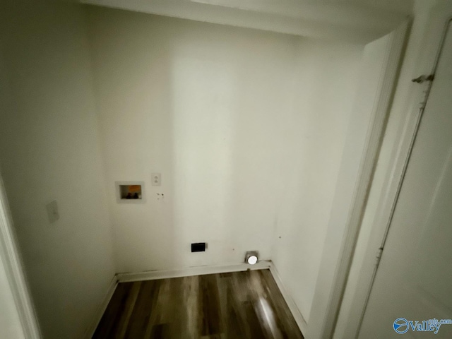 clothes washing area featuring washer hookup, wood finished floors, and baseboards