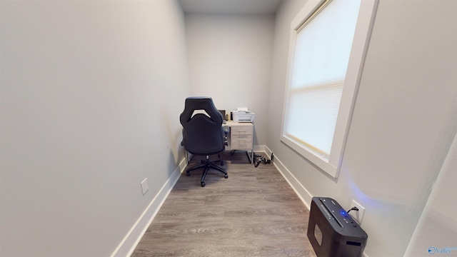 home office with light hardwood / wood-style flooring