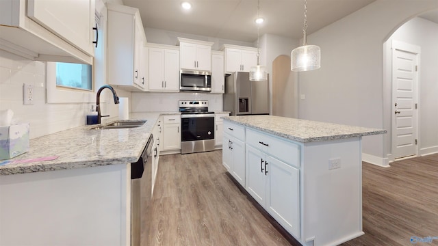 kitchen with white cabinetry, sink, a center island, and appliances with stainless steel finishes