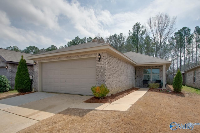 single story home featuring concrete driveway, an attached garage, and brick siding