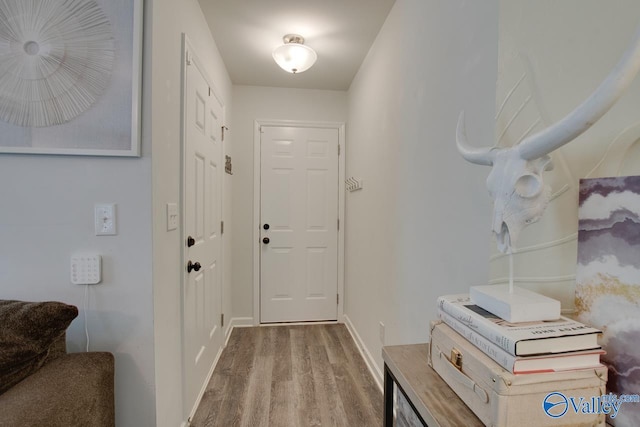 interior space featuring baseboards and wood finished floors