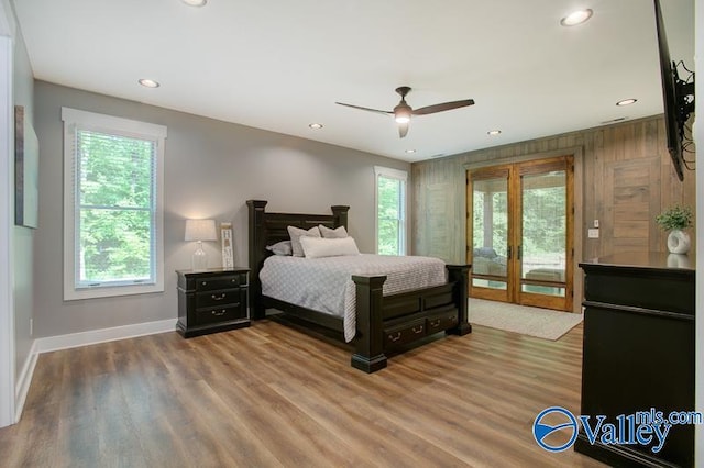 bedroom featuring french doors, wood finished floors, baseboards, access to outside, and recessed lighting
