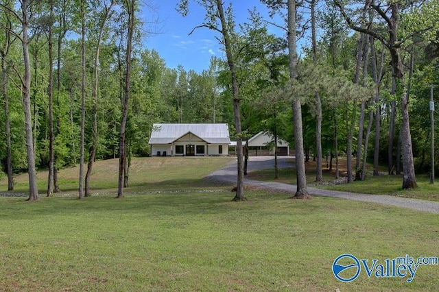 ranch-style home with a front lawn and aphalt driveway