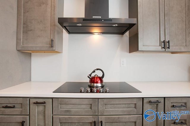 kitchen with light countertops, black electric stovetop, and extractor fan