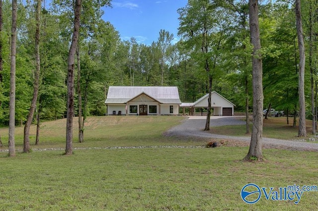 single story home with aphalt driveway and a front yard