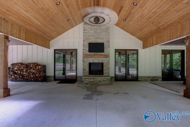 unfurnished living room featuring wooden ceiling, a fireplace, french doors, and high vaulted ceiling