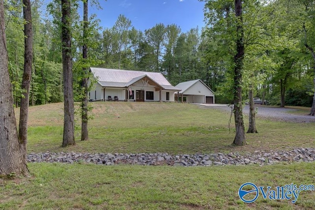 ranch-style house featuring a garage, driveway, and a front lawn