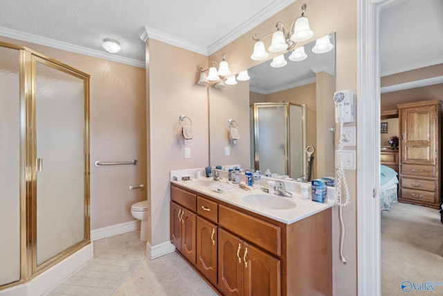 bathroom featuring crown molding, vanity, a shower with shower door, tile patterned floors, and toilet