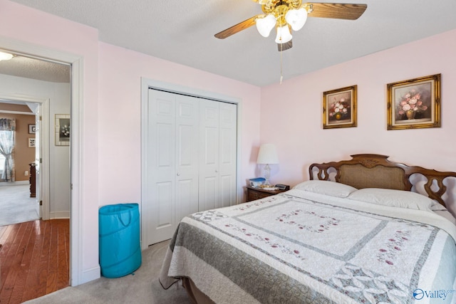 carpeted bedroom with ceiling fan and a closet