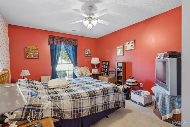 carpeted bedroom with a textured ceiling and ceiling fan