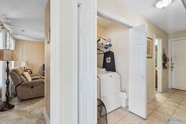 interior space featuring washer and clothes dryer and a textured ceiling