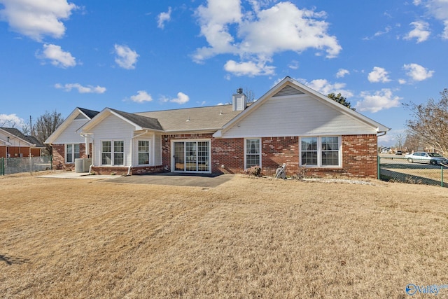 back of property featuring a yard