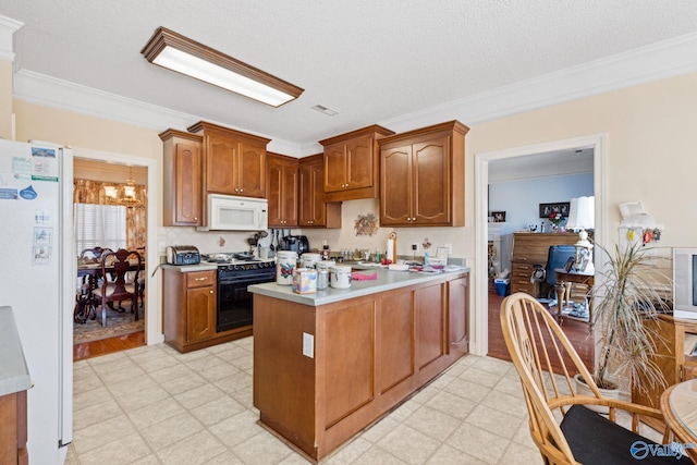 kitchen featuring crown molding, an inviting chandelier, a textured ceiling, and white appliances