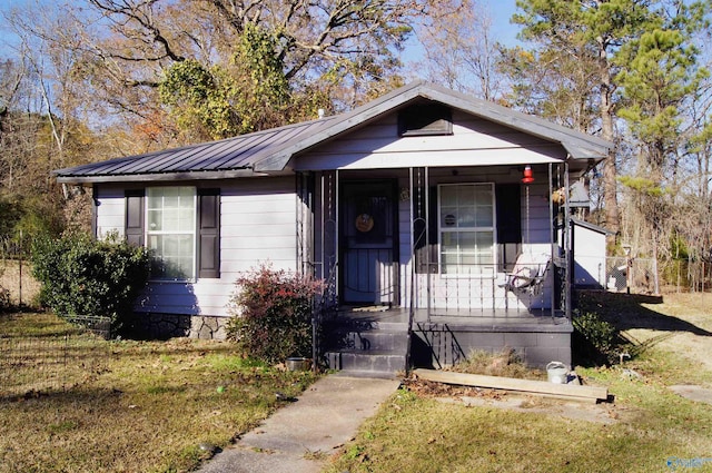 bungalow-style house featuring a porch and a front lawn