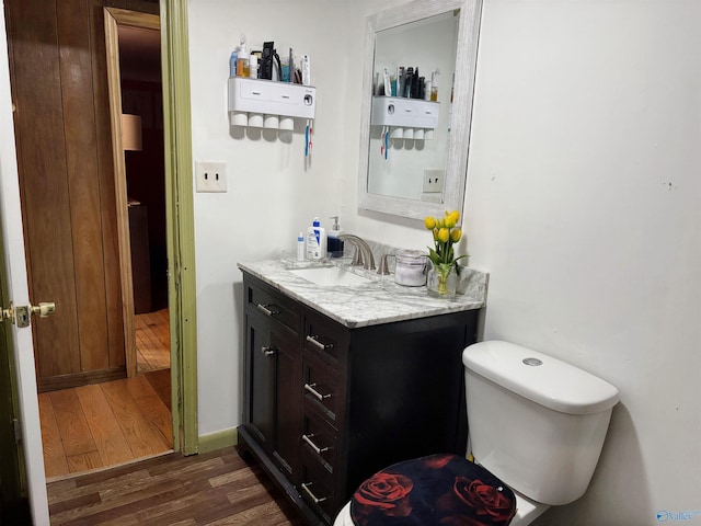 bathroom with vanity, hardwood / wood-style flooring, and toilet