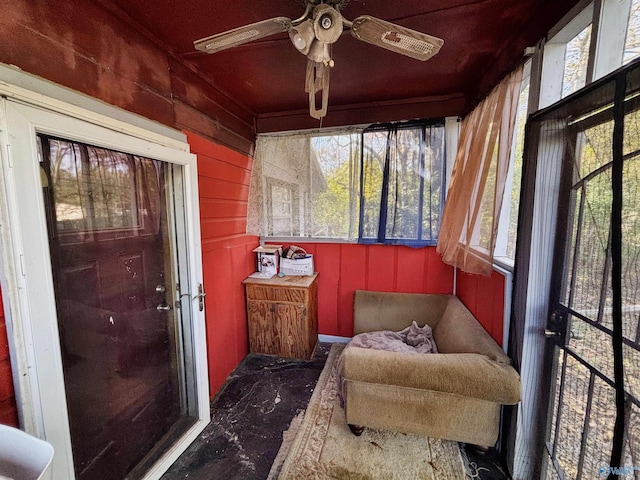 sunroom featuring ceiling fan and a healthy amount of sunlight