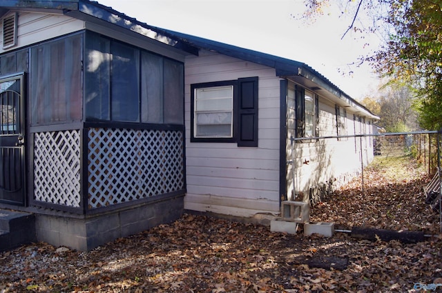 view of side of property featuring a sunroom