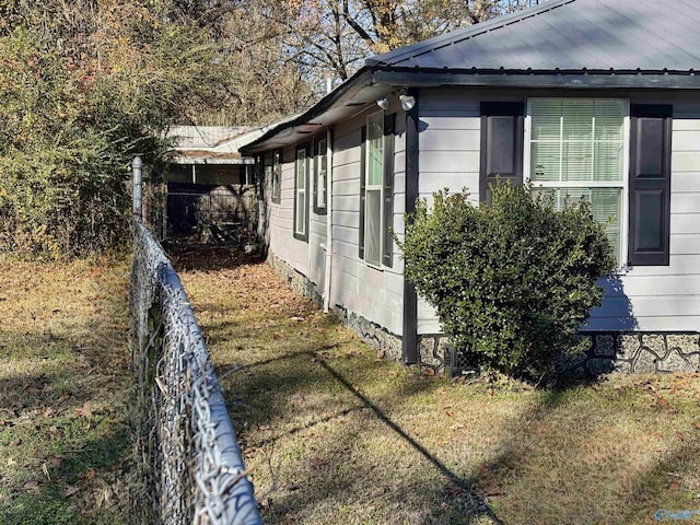 view of side of property with a yard