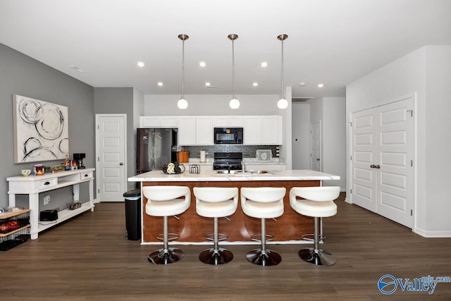 27091 Rabbit Run, Athens, AL 35613 - kitchen featuring black appliances, white cabinetry, a breakfast bar, tasteful backsplash, and recessed lighting