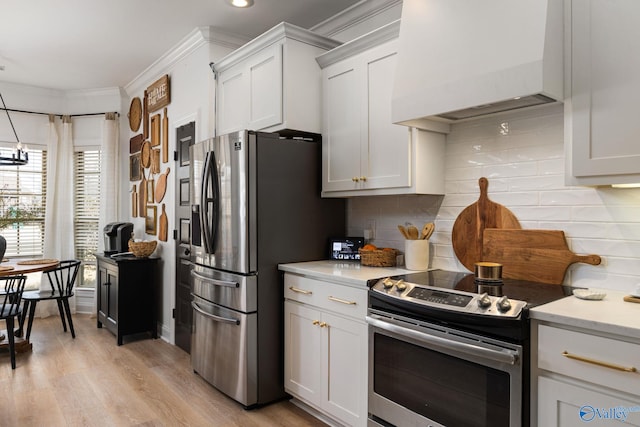 kitchen with backsplash, light wood-style floors, appliances with stainless steel finishes, crown molding, and custom exhaust hood