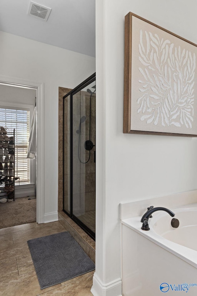 full bath featuring a shower stall, a bath, baseboards, and visible vents