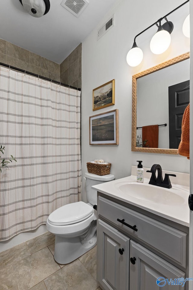 bathroom featuring vanity, tile patterned floors, toilet, and visible vents