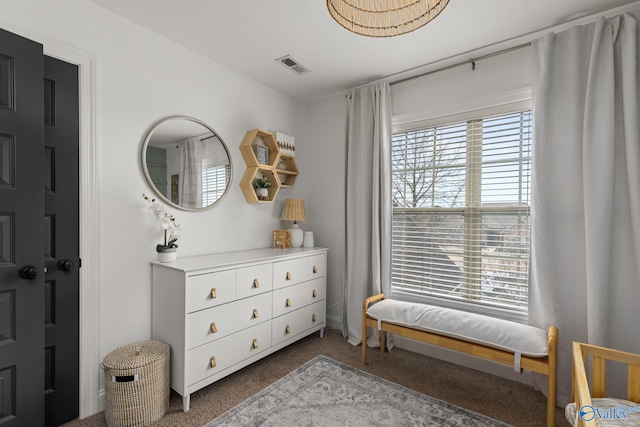 bedroom featuring dark colored carpet and visible vents