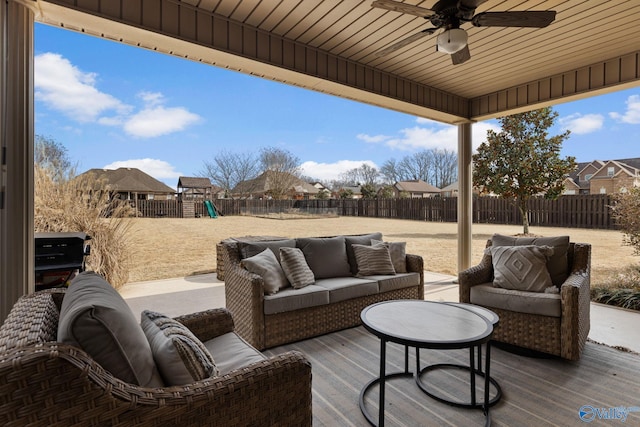 view of patio featuring an outdoor living space, a fenced backyard, ceiling fan, and a playground