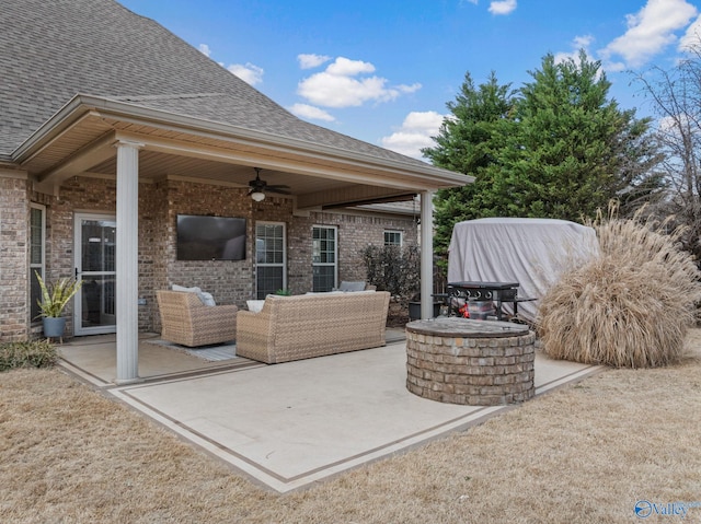 view of patio / terrace with an outdoor living space with a fire pit and ceiling fan