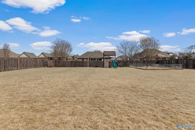 view of yard featuring a playground and a fenced backyard